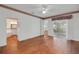 Spacious bedroom with wood floors, ceiling fan, and sliding glass doors to the lanai at 32948 Rambling Oaks Ct, Leesburg, FL 34748