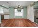 Dining area shows wood flooring, a chandelier, and scenic view through window at 32948 Rambling Oaks Ct, Leesburg, FL 34748