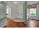 Inviting entryway with a blend of wood and tiled flooring, and views to dining and kitchen at 32948 Rambling Oaks Ct, Leesburg, FL 34748