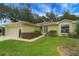Charming single-story home with well-manicured lawn and mature landscaping, and a two car garage at 32948 Rambling Oaks Ct, Leesburg, FL 34748