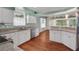 Bright kitchen featuring granite countertops, stainless steel appliances, and wood flooring at 32948 Rambling Oaks Ct, Leesburg, FL 34748