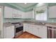 Bright kitchen featuring granite counters, stainless steel appliances, and white cabinetry at 32948 Rambling Oaks Ct, Leesburg, FL 34748