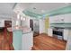 Spacious kitchen features granite countertops, stainless appliances, and sleek white cabinetry at 32948 Rambling Oaks Ct, Leesburg, FL 34748