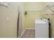Efficient laundry room with shelving and a modern washing machine at 32948 Rambling Oaks Ct, Leesburg, FL 34748