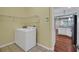 Functional laundry area includes shelving for storage and a modern washer at 32948 Rambling Oaks Ct, Leesburg, FL 34748