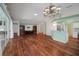 Spacious living room with hardwood floors, custom built-ins, and a light mint accent wall at 32948 Rambling Oaks Ct, Leesburg, FL 34748