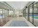 Bright sunroom featuring tiled floors, ceiling fan, and access to the outdoor pool area through sliding glass doors at 32948 Rambling Oaks Ct, Leesburg, FL 34748