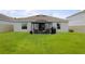 Spacious backyard featuring a gazebo with outdoor furniture and a grill for entertaining at 33647 Sky Blossom Cir, Leesburg, FL 34788