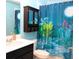 Vibrant bathroom featuring a vanity with a storage cabinet and a decorative shower curtain at 33647 Sky Blossom Cir, Leesburg, FL 34788