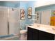 Bright bathroom with a double sink vanity, glass-enclosed shower, and modern fixtures for a spa-like experience at 33647 Sky Blossom Cir, Leesburg, FL 34788