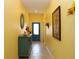Bright hallway with decorative wall art and furniture showcasing the home's welcoming ambiance at 33647 Sky Blossom Cir, Leesburg, FL 34788