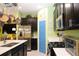 Well-equipped kitchen with a stainless steel refrigerator, microwave, and black cabinets against bright wall colors at 33647 Sky Blossom Cir, Leesburg, FL 34788