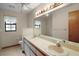 Bright bathroom with a double sink vanity, large mirror and tiled flooring at 37236 Cherry Lake Rd, Fruitland Park, FL 34731