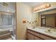 Bright bathroom with double sinks, shower, large mirror, and tiled floors at 37236 Cherry Lake Rd, Fruitland Park, FL 34731