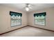 Neutral carpeted bedroom with ceiling fan and windows offering a view outside at 37236 Cherry Lake Rd, Fruitland Park, FL 34731