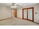 Bright bedroom featuring ceiling fan with backyard patio doors allowing plenty of natural light at 37236 Cherry Lake Rd, Fruitland Park, FL 34731