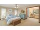 Bright bedroom featuring a coastal style with blue accents and an en-suite bathroom at 37236 Cherry Lake Rd, Fruitland Park, FL 34731