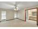 Spacious primary bedroom adjacent to bathroom featuring ceiling fan and natural light at 37236 Cherry Lake Rd, Fruitland Park, FL 34731