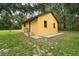 Exterior of yellow building with a white door and small porch with stairs at 37236 Cherry Lake Rd, Fruitland Park, FL 34731