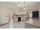 Traditional kitchen with white cabinets and black appliances, adjacent to laundry room at 37236 Cherry Lake Rd, Fruitland Park, FL 34731
