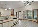Kitchen with white cabinets, breakfast bar, and view of the fireplace and outside at 37236 Cherry Lake Rd, Fruitland Park, FL 34731