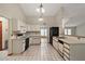 Spacious kitchen with white cabinets, black appliances, and open layout to dining area at 37236 Cherry Lake Rd, Fruitland Park, FL 34731