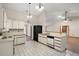 Kitchen featuring white cabinets, black appliances, and an open layout to the living area at 37236 Cherry Lake Rd, Fruitland Park, FL 34731