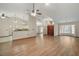 Bright, open-concept living area with wood floors, ceiling fan, and view of front entryway at 37236 Cherry Lake Rd, Fruitland Park, FL 34731