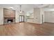 Open living room with hardwood floors, a cozy fireplace, and natural light at 37236 Cherry Lake Rd, Fruitland Park, FL 34731