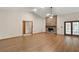 Spacious living room featuring a brick fireplace, wood flooring, and sliding glass doors at 37236 Cherry Lake Rd, Fruitland Park, FL 34731