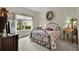 Comfortable bedroom with a metal bed frame, side table, and large window providing natural light at 3819 Saint Emma Ct, Leesburg, FL 34748