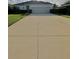 Charming single-story home featuring a well-manicured lawn and a long driveway leading to a two-car garage at 3819 Saint Emma Ct, Leesburg, FL 34748
