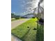 Well-manicured lawn and landscape with home featuring a long driveway leading to a two-car garage at 3819 Saint Emma Ct, Leesburg, FL 34748