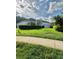 Charming single-story home featuring a well-manicured lawn and a long driveway leading to a two-car garage at 3819 Saint Emma Ct, Leesburg, FL 34748