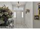 Elegant foyer featuring tile flooring, a chandelier, and a view of the front door with sidelights at 3819 Saint Emma Ct, Leesburg, FL 34748