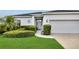 Charming single-story home with a three-car garage and attractive landscaping around the front door at 3819 Saint Emma Ct, Leesburg, FL 34748
