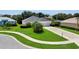 Inviting home with green lawn, mature landscaping, and a concrete driveway that leads to a three car garage at 3819 Saint Emma Ct, Leesburg, FL 34748