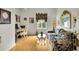 Home office featuring hardwood floors, a decorative couch, and a workspace with a desk and chair at 3819 Saint Emma Ct, Leesburg, FL 34748