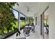 Relaxing screened patio features a ceiling fan and views of the well-manicured lawn at 3819 Saint Emma Ct, Leesburg, FL 34748