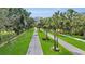 Scenic street view of a beautifully landscaped road lined with mature trees and manicured lawns at 3819 Saint Emma Ct, Leesburg, FL 34748