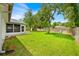 Picture of the backyard, which is fenced and features plenty of trees, lush grass, and a shed at 39 Pine Court Dr, Ocala, FL 34472