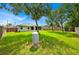 This image shows the wide, tree-lined backyard with privacy fence, well, and screened-in lanai at 39 Pine Court Dr, Ocala, FL 34472
