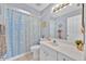 Updated bathroom with a cute shower curtain and modern vanity at 39 Pine Court Dr, Ocala, FL 34472
