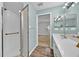 Well-lit bathroom with a walk-in shower, tile floors and an integrated vanity at 39 Pine Court Dr, Ocala, FL 34472