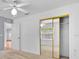 Bright bedroom featuring neutral carpet, a ceiling fan, and sliding mirrored closet doors at 39 Pine Court Dr, Ocala, FL 34472