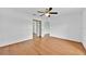 Neutral bedroom with hardwood flooring and sliding door closet at 39 Pine Court Dr, Ocala, FL 34472