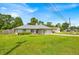 Exterior view of this well-maintained single-Gathering home with lush front lawn, bushes, and driveway at 39 Pine Court Dr, Ocala, FL 34472