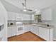 Well-equipped kitchen featuring white cabinets, wood floors, and stainless-steel appliances at 39 Pine Court Dr, Ocala, FL 34472