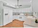 Well-lit kitchen featuring white appliances, wood floors, and plenty of counter space at 39 Pine Court Dr, Ocala, FL 34472