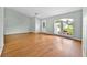 Inviting living room with wood floors, bright window, and neutral paint at 39 Pine Court Dr, Ocala, FL 34472